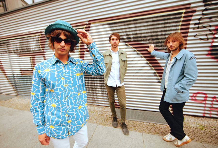 The band in front of a graffiti-covered shutter