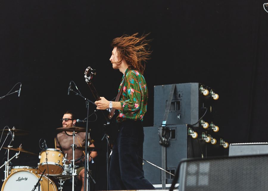 Bassist with flying hair, drummer behind