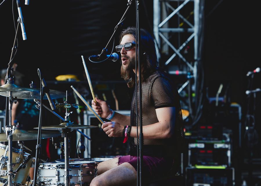 Drummer singing into the mic